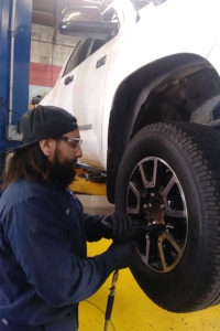 Mechanic David taking tires off of a truck