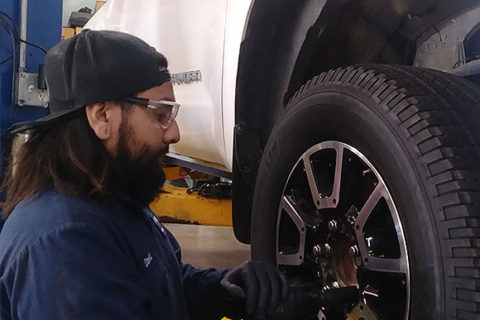 Mechanic David taking tires off of a truck