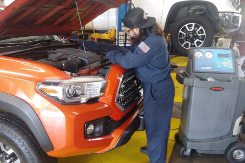 Another angle of Mechanic David working on a truck