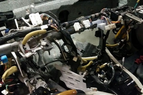 Image of a vehicles dashboard completely taken apart- Driver's side angle